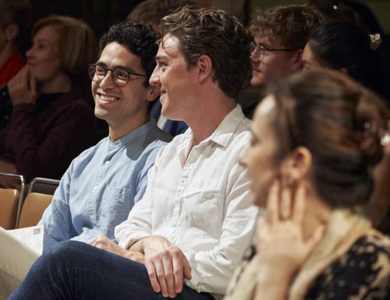 Two people happily watching an LCO concert