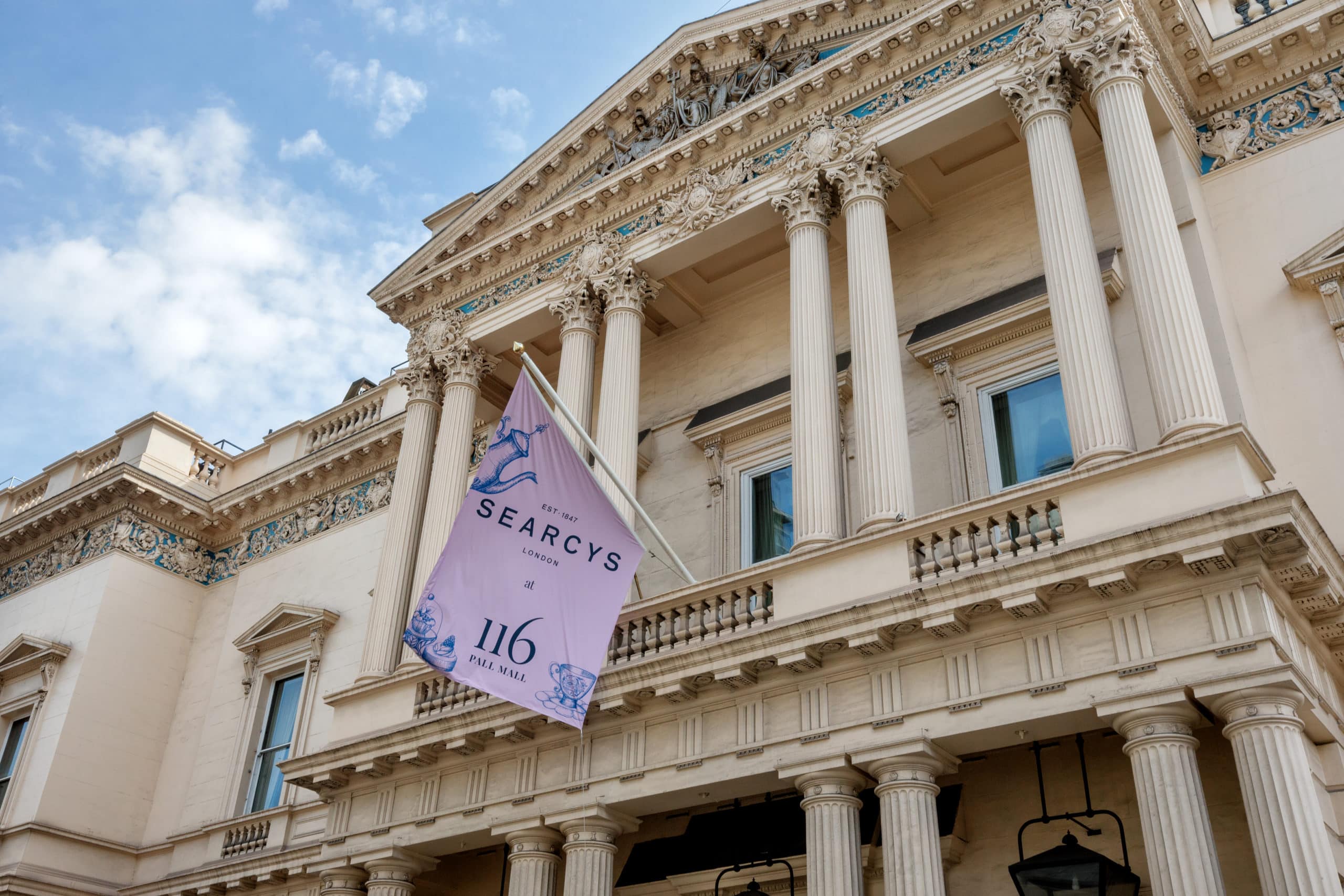 Front of 116 Pall Mall with a purple flag showing the Searcys and 116 Pall Mall logos